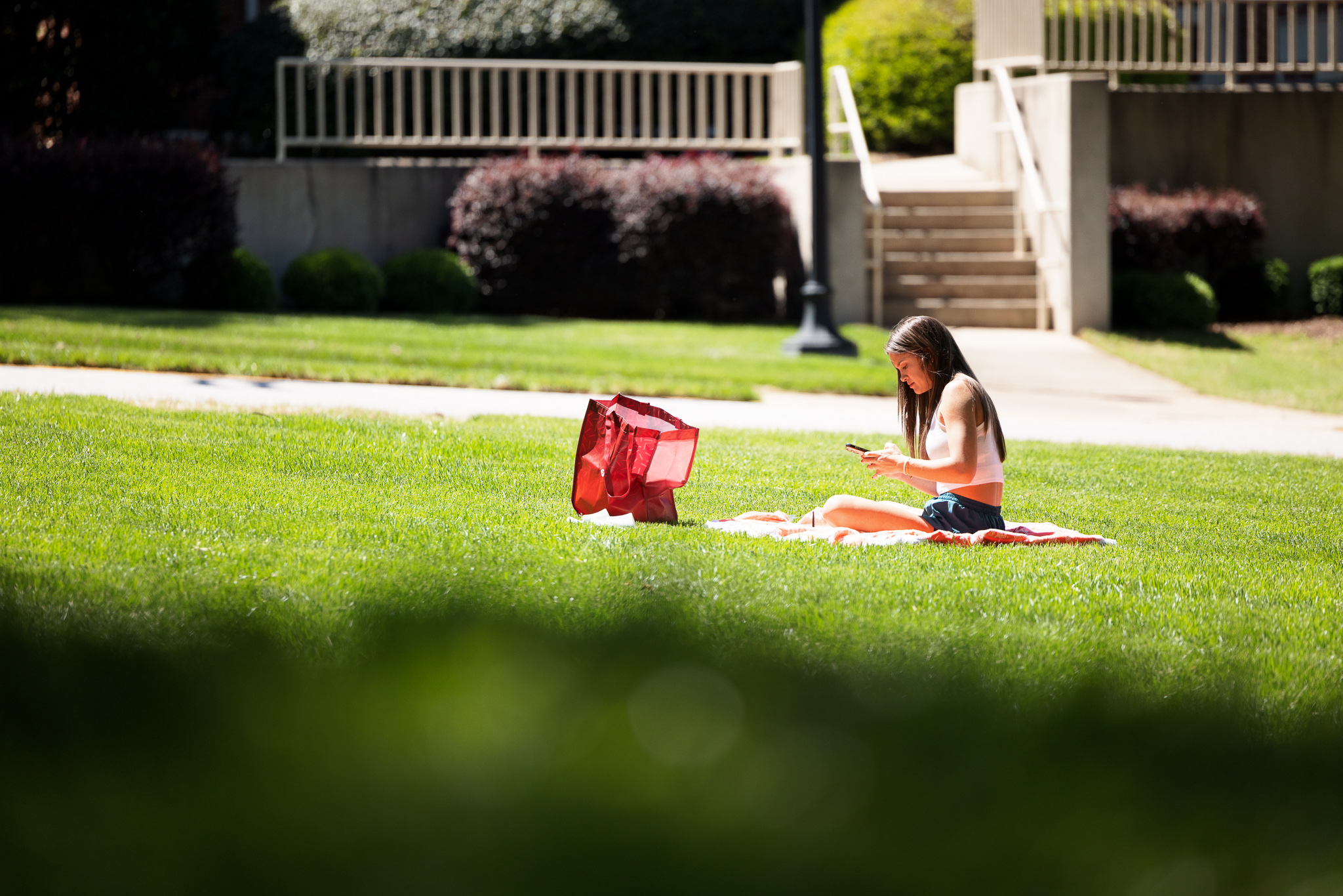 Presbyterian College student sitting outside in grass