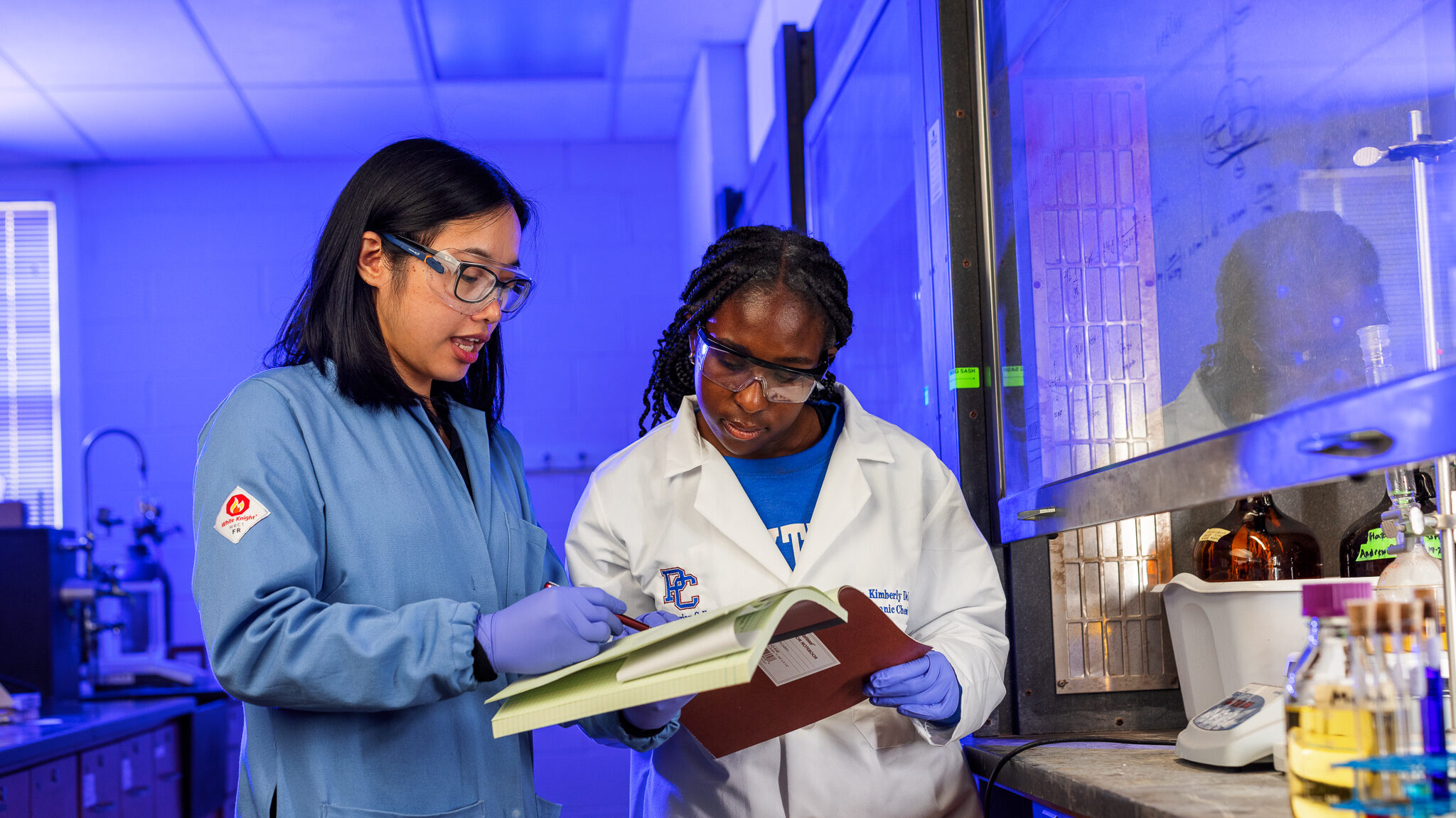 Presbyterian College student working in a chemistry lab with a professor.