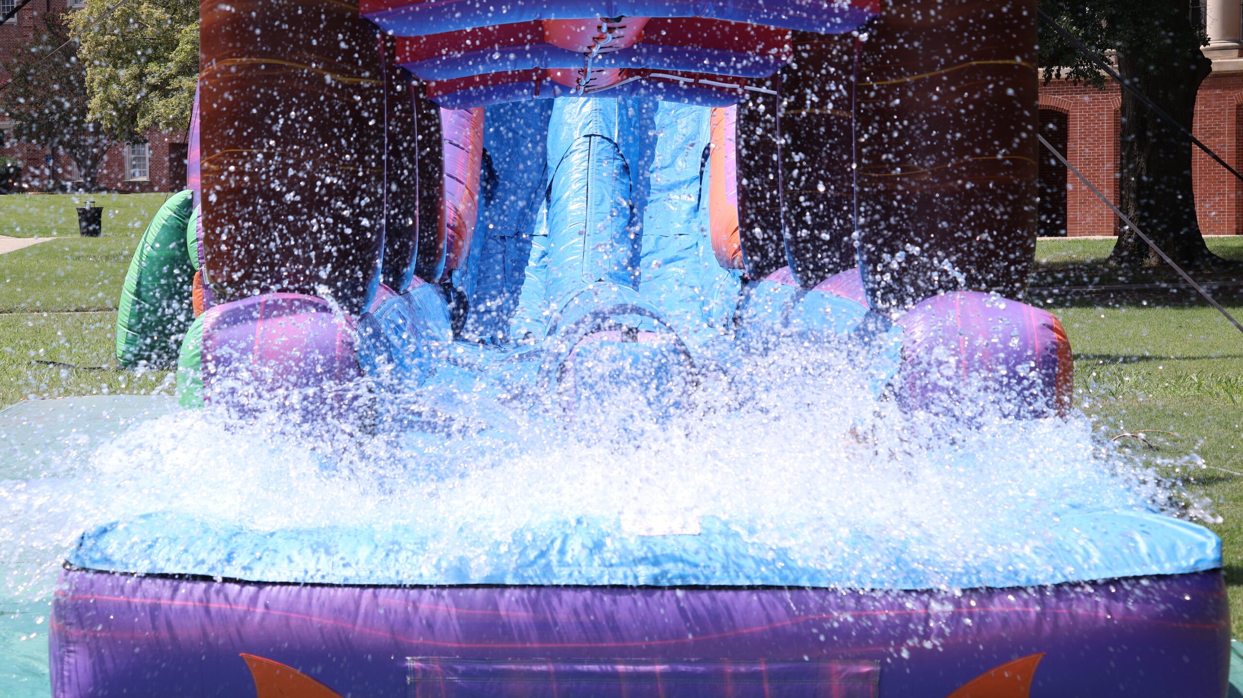 Presbyterian College students making a splash with a water slide during orientation week.