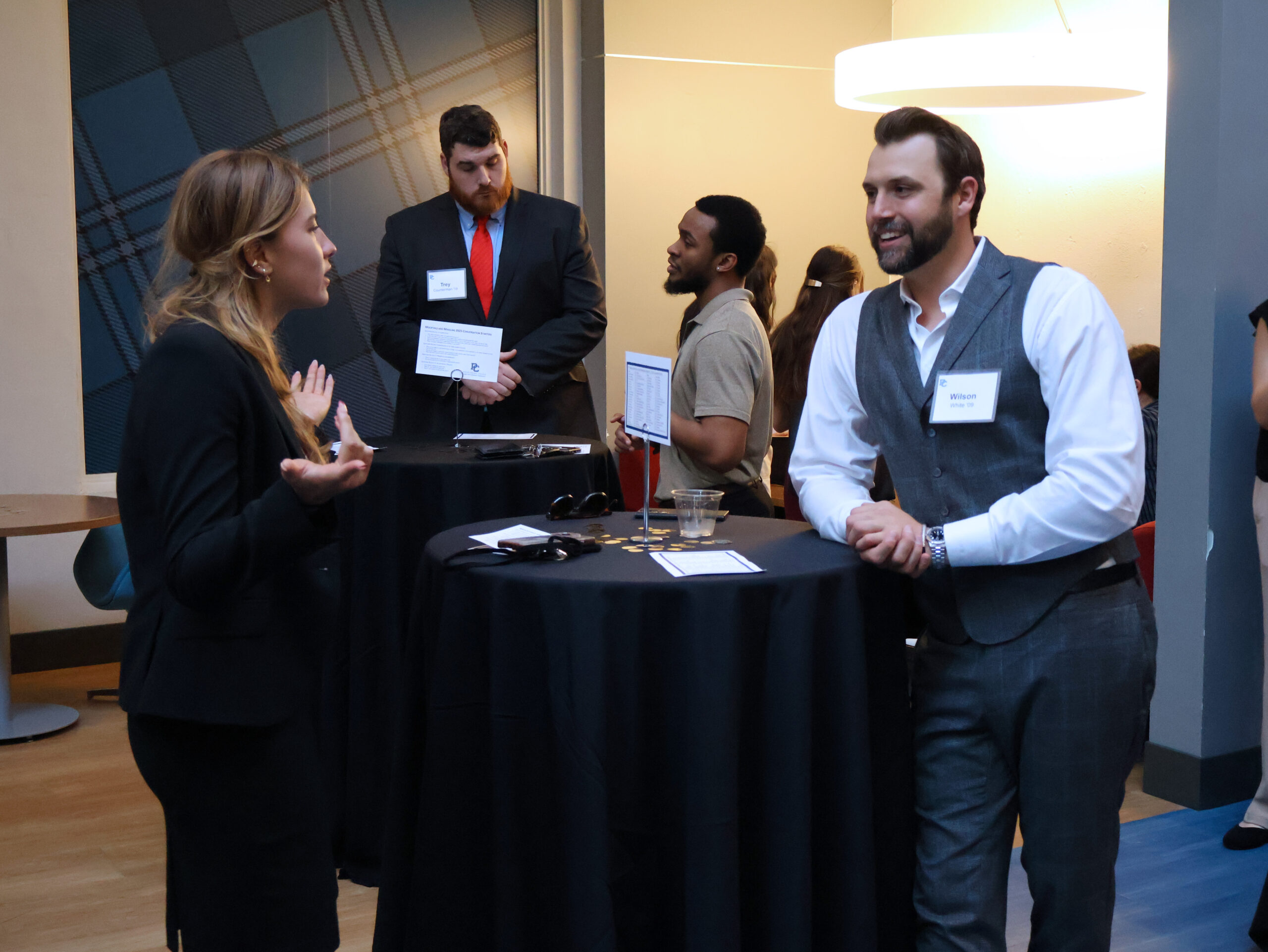 Presbyterian College alumni and student networking at an event.