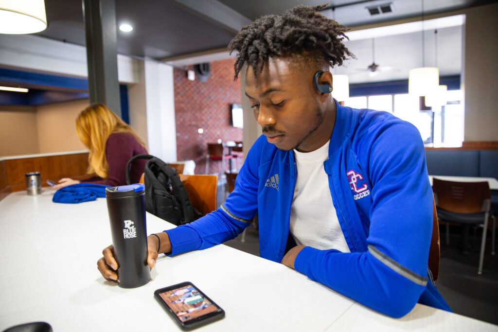 PC student on his phone in Springs.