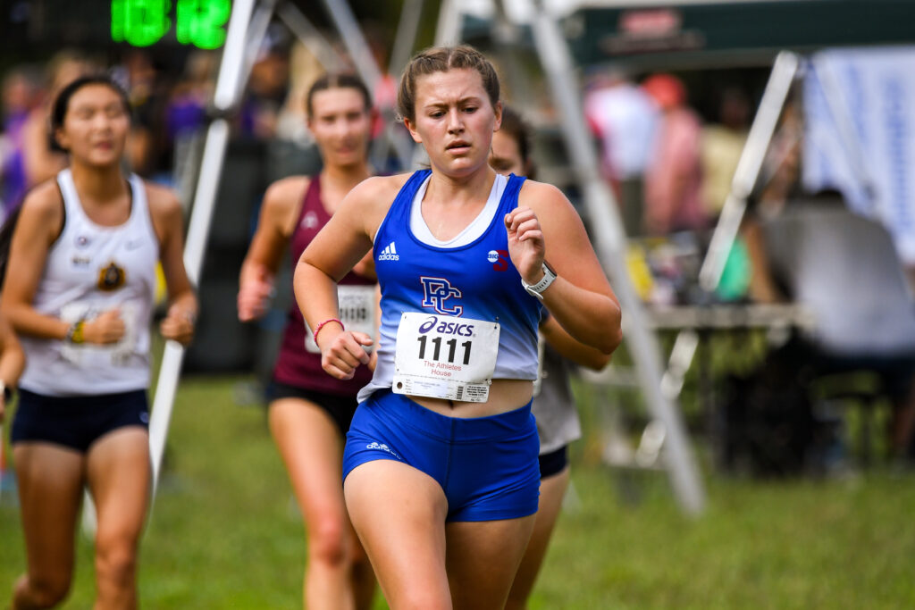Caroline Rairigh '25 running in a cross country meet. 