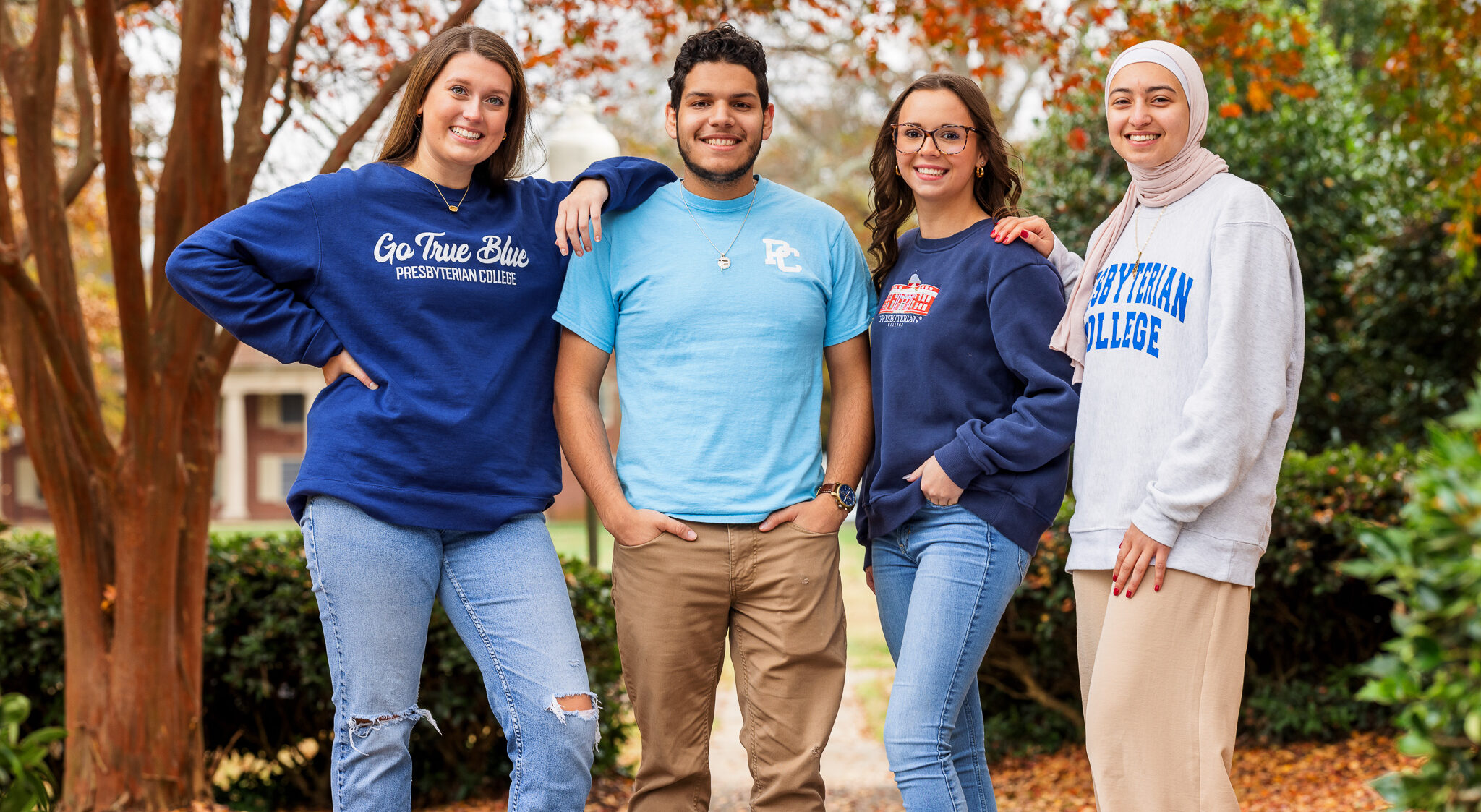 Students standing together at PC for a photo.