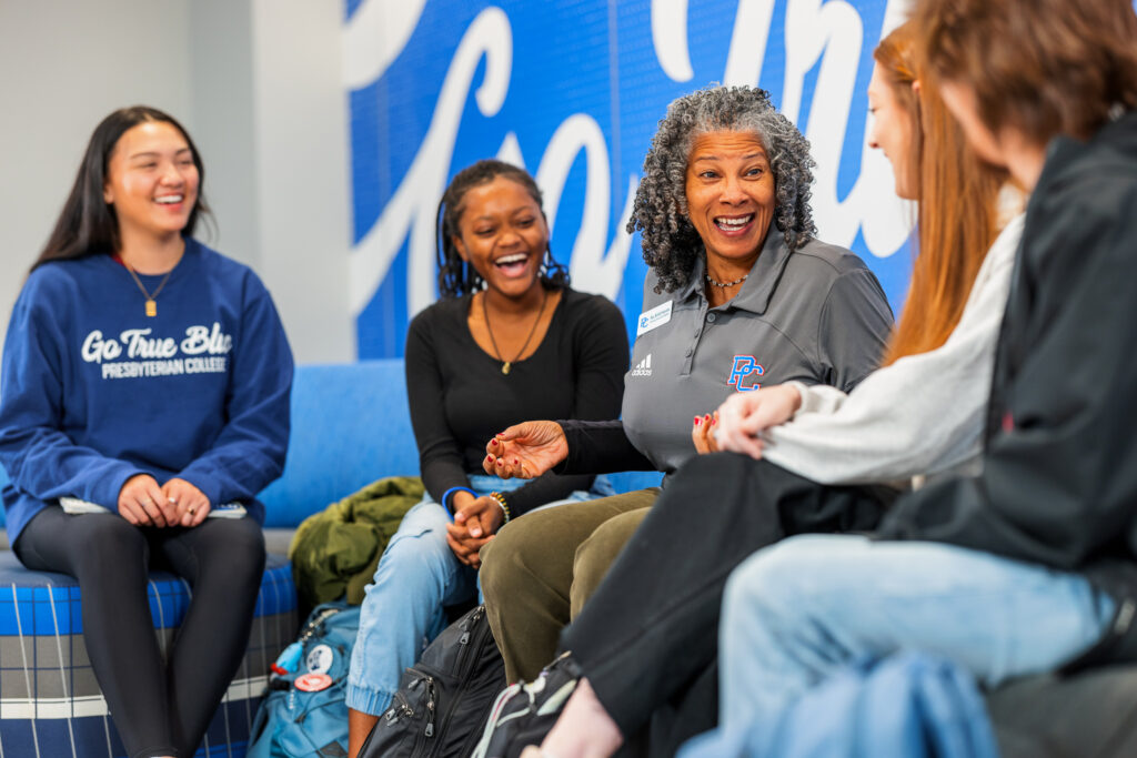 Students laughing with Rev. Dr. British Hyrams. 