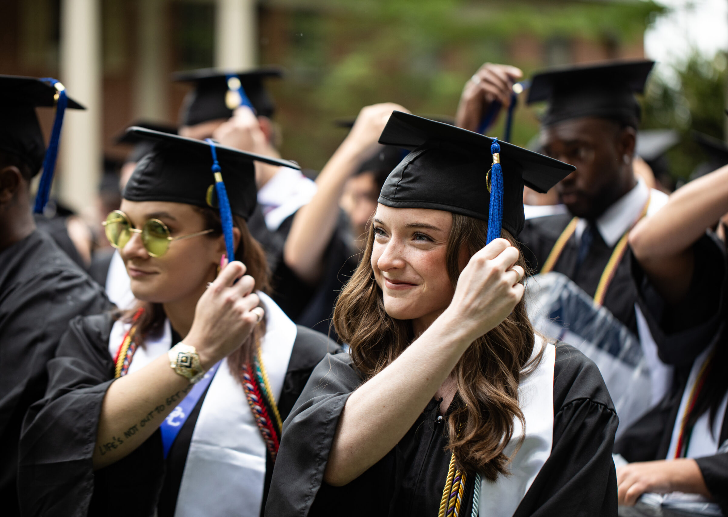 Presbyterian College students flip their tassels on their caps to the side.