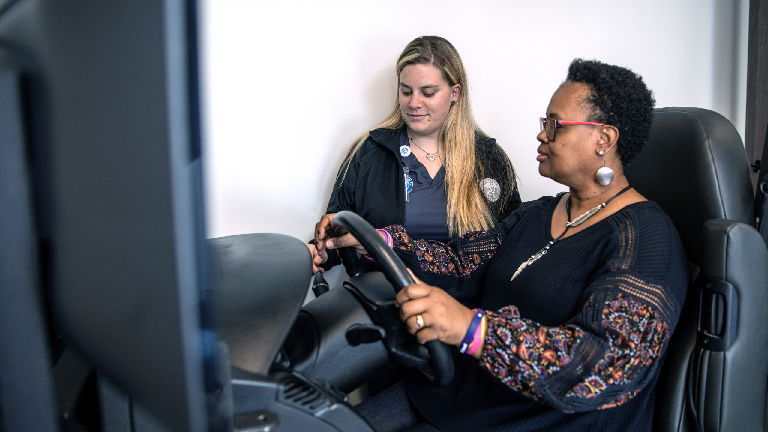Presbyterian College Occupational Therapy Student assisting with patient in our driving simulator.