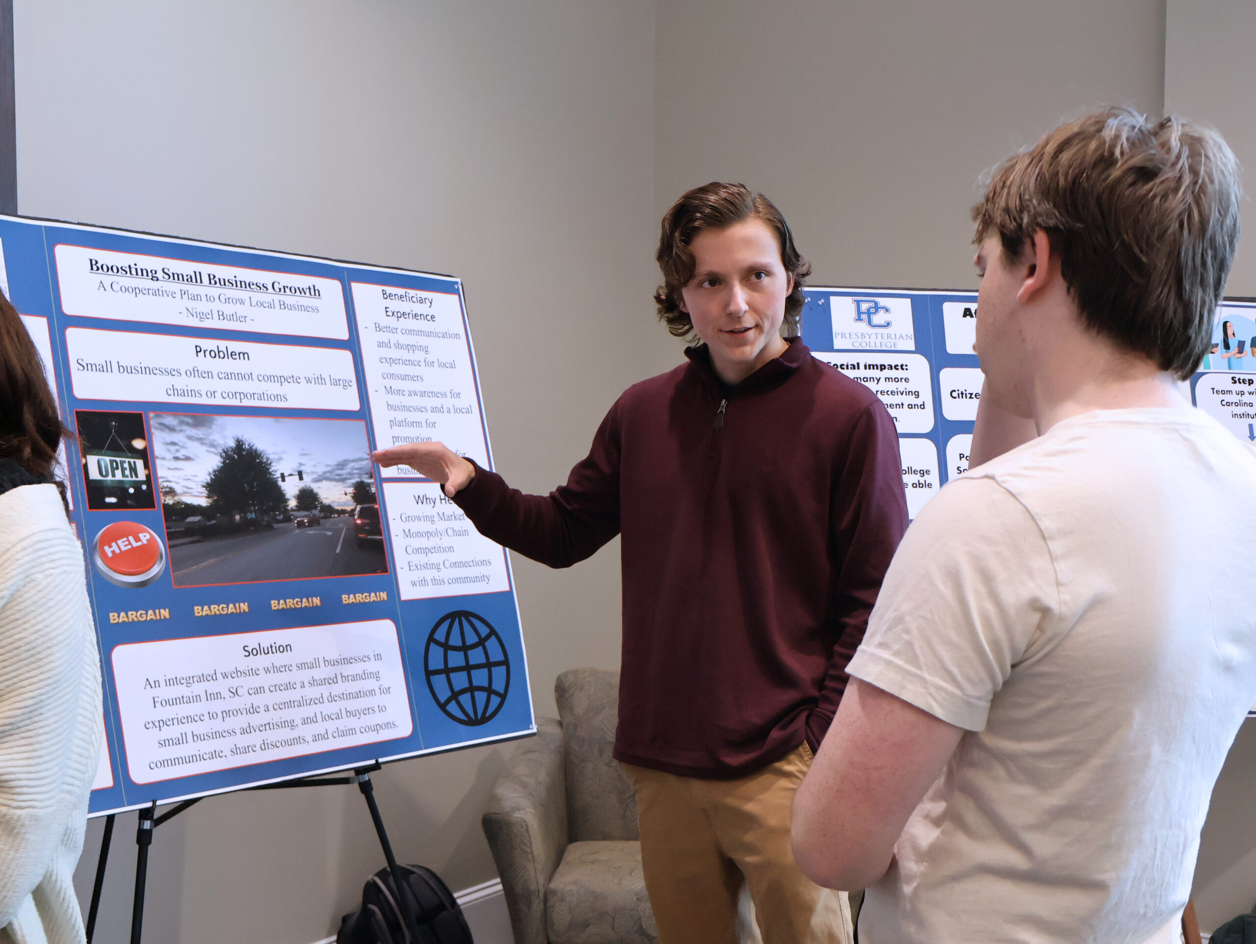 Presbyterian College student sharing his Service Entrepreneurship project with another student.