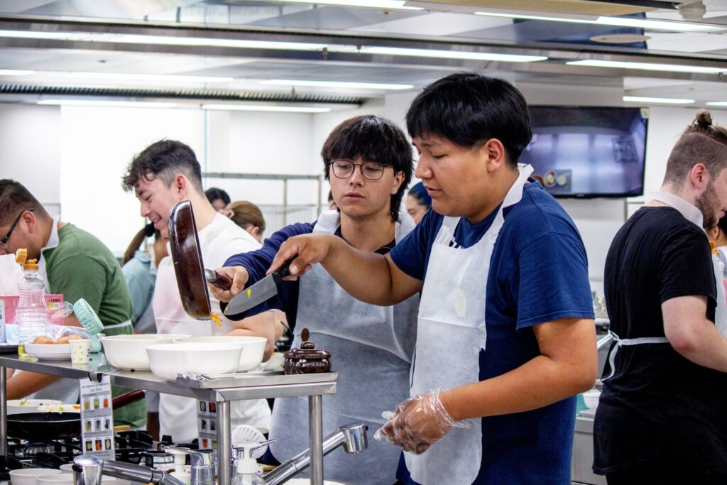 A photo of Korea Scholars cooking. 