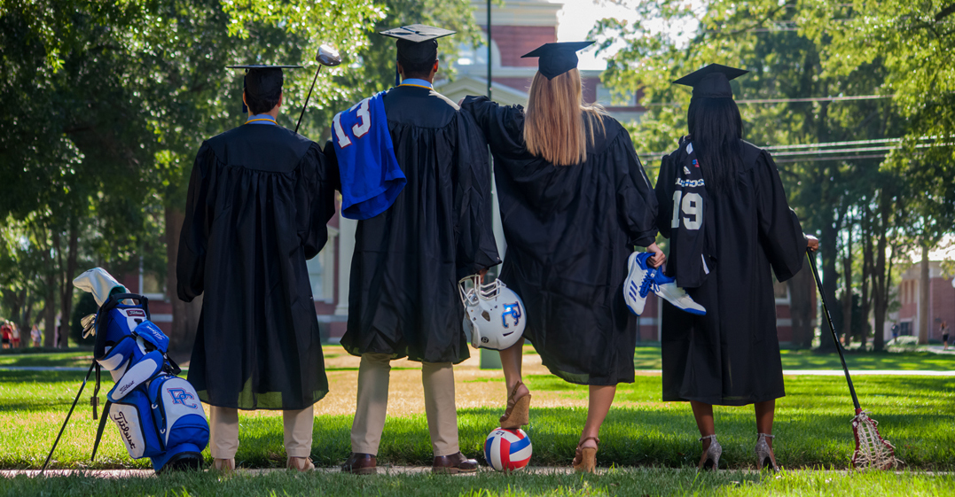 Presbyterian College senior athletes in their cap, gowns, and their athletic equipment.
