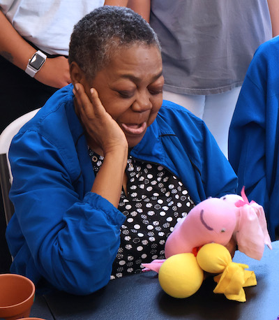 An adult worker at Evergreen Skills shows off her handiwork at the second annual Spring for Evergreen event organized by Presbyterian College Occupational Therapy students.
