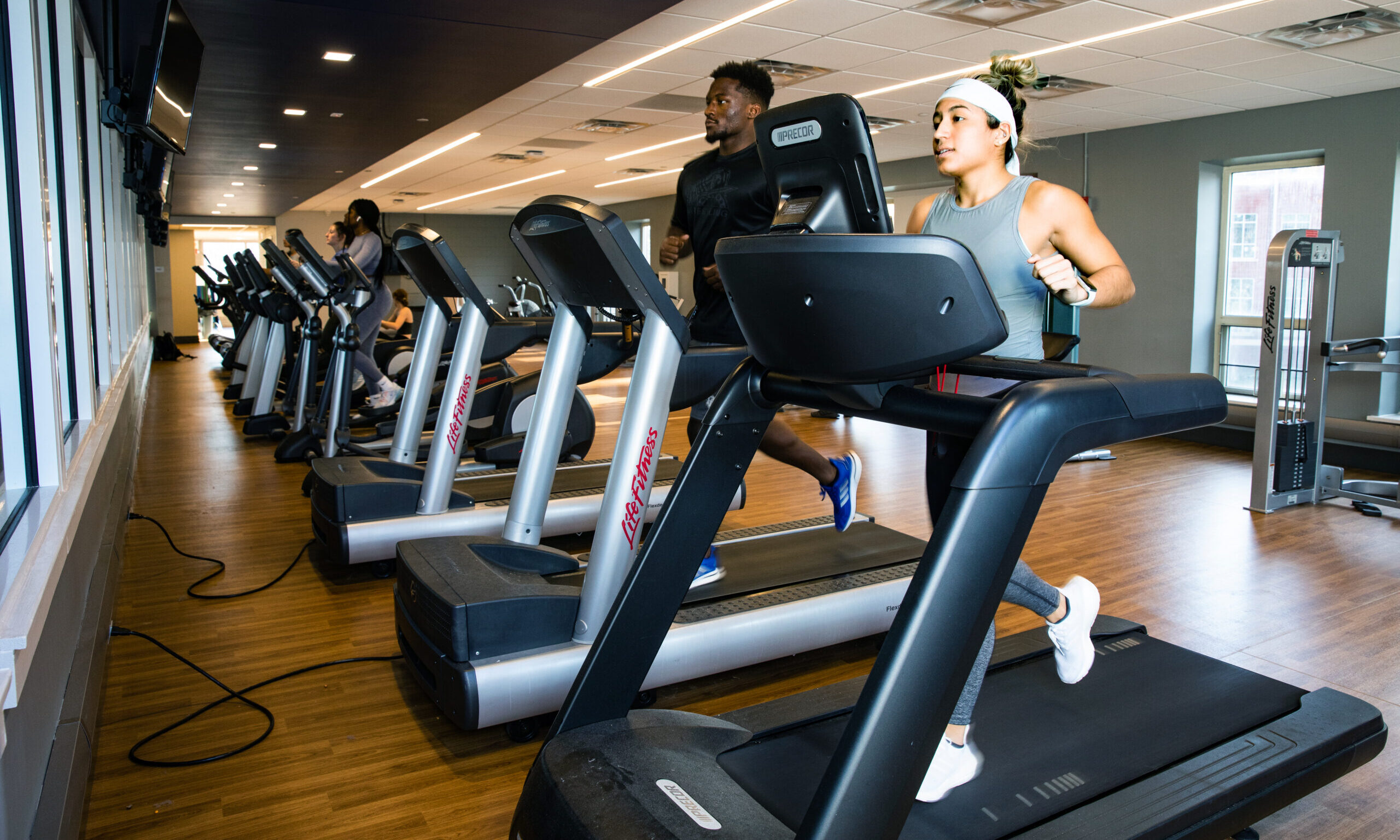 Presbyterian Collge students running on treadmills in the student fitness center.